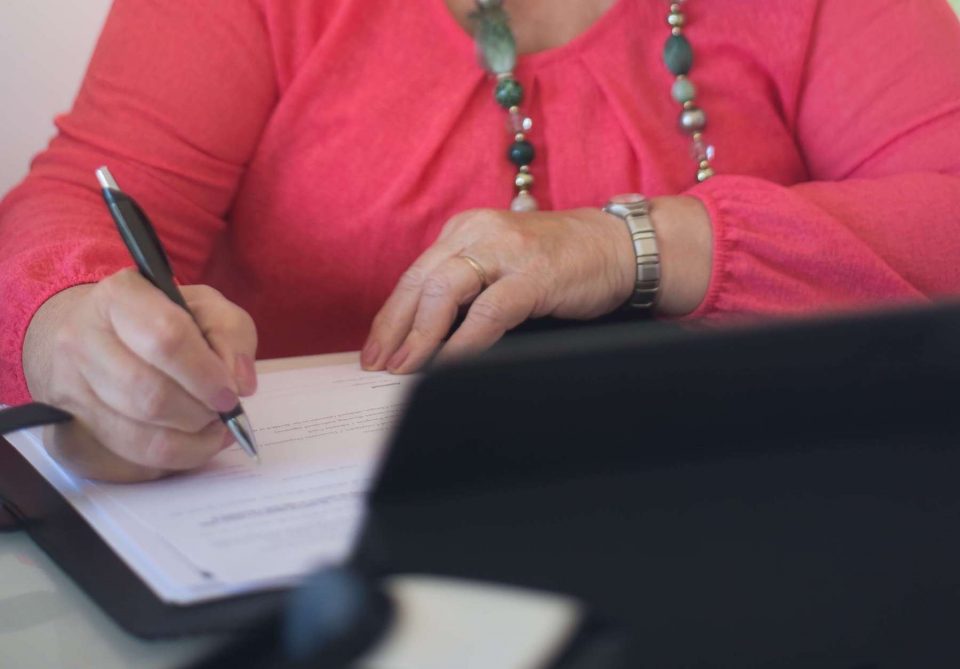 woman signing papers cropped