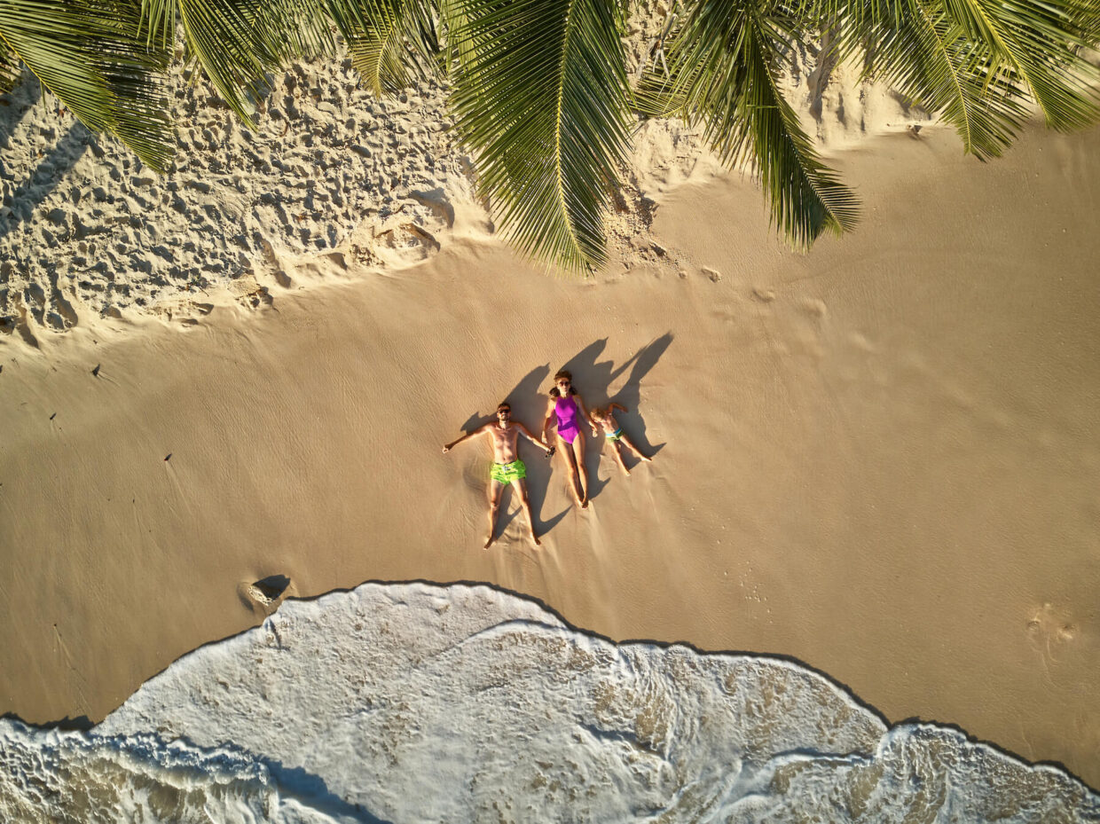 family on beach at seychelles aerial top view 2021 08 28 04 35 27 utc